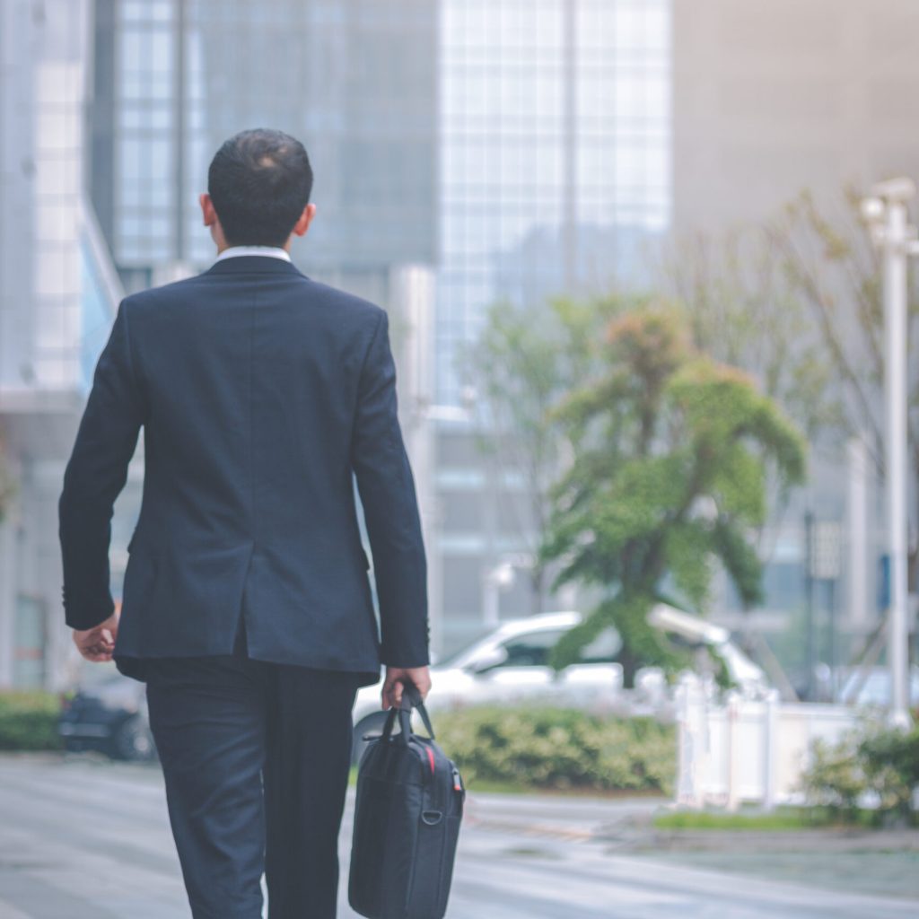 young businessman walking outside office